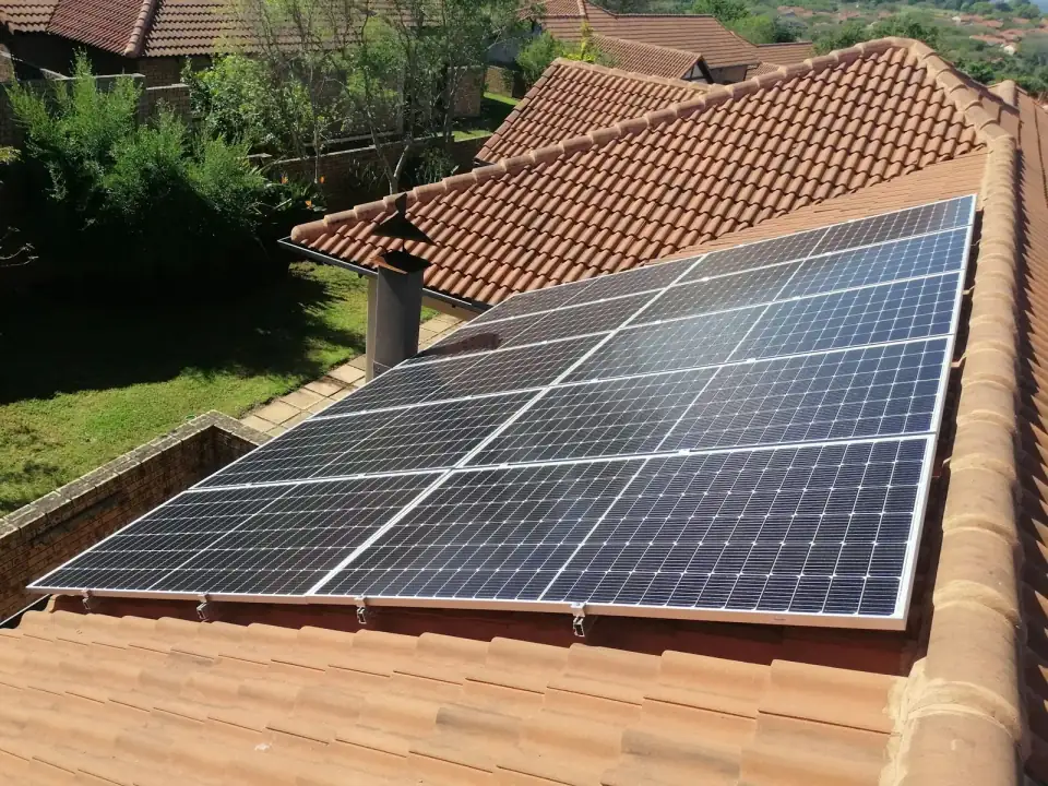 Zonnepanelen op een dak met rode dakpannen, van bovenaf gezien